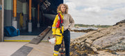 Woman wearing RNLI gear spilt with Finisterre knitwear