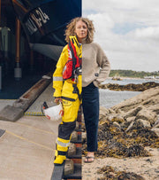 Woman wearing RNLI gear spilt with Finisterre knitwear