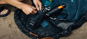 Changing mat bag with the DAME collaboration product and ocean bottle sitting on it